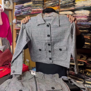 Black and White Checkered Long-Sleeve Jacket with Front Flap Pockets and Button Closure